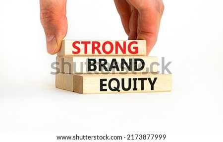 Strong brand equity symbol. Concept words Strong brand equity on wooden blocks on a beautiful white table white background. Businessman hand. Business, finacial and strong brand equity concept.