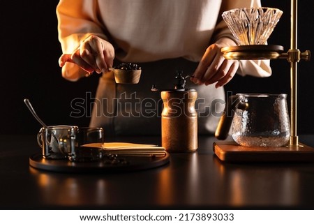 Grinding coffee beans, barista making handcrafted artisan coffee - stock photo
