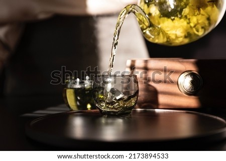 Tea artist pouring pure jasmine tea, a traditional Chinese beverage - stock photo