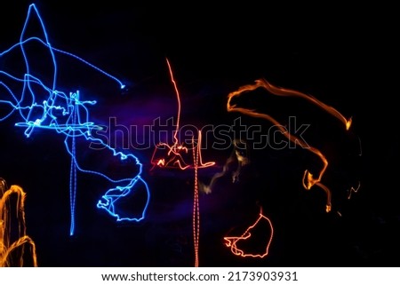 Lights in dark. Movement of glowing lines. Details of light music. Abstract texture neon glow.