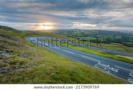 Sunset at the hairpin bend on the A4069, the Black Mountain Pass in South Wales UK often used in a popular TV car series because of the fast winding roads Royalty-Free Stock Photo #2173909769