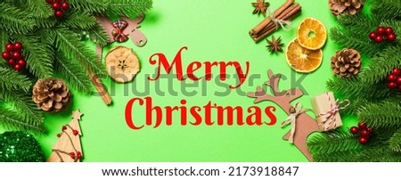 Merry Christmas text. Top view Banner of Christmas decorations on green background. New Year holiday concept with copy space.