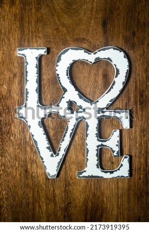 white love letters on wooden wall. The concept of happiness, peace, brotherhood, beautiful world
