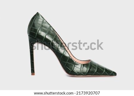 Emerald pointy toe women's shoes with high heels isolated on white background. Green Female classic stiletto heels in crocodile skin leather. Single. Mock up, template Royalty-Free Stock Photo #2173920707