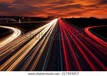 Speed Traffic - light trails on motorway highway at night,  long exposure abstract urban background Royalty-Free Stock Photo #217393057