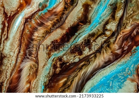 A liquid blend of paint colors creates an acrylic texture. Background of abstract fluid art. Colorful swirls and easy forms are used in this painting. Modern backdrop with mixing dye effect