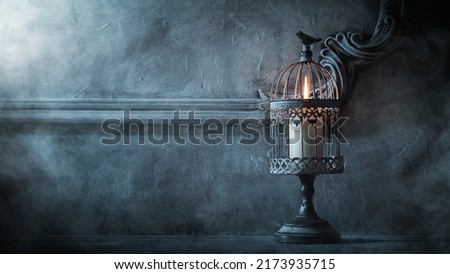 Mystical Halloween still-life background. Candlestick with candles, old fireplace. Horror and witchery.