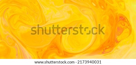 Fluid Art. Abstract golden orange backdrop. Yellow and orange paint pigment background