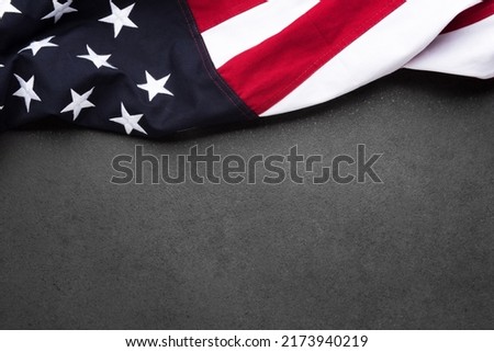 The flag of the United States of America on a gray textured background with copy space