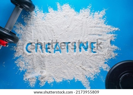 the word creatine written on a white powder. wellness concept. Royalty-Free Stock Photo #2173955809
