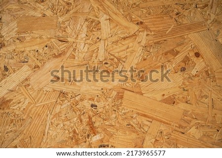 OSB board texture. Brown wooden background. Simple pressed chipboard pattern. Brown wood texture. Chip board background. 