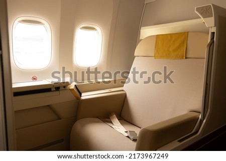 Luxury first class or business class suite on airplane in gold color feel private for travel.Business comfort and eleglance chair when fly with airline. Royalty-Free Stock Photo #2173967249