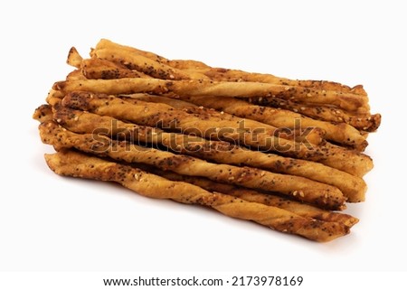 Salted baked sticks with sesame and poppy seeds isolated on bright background. Close up view.
