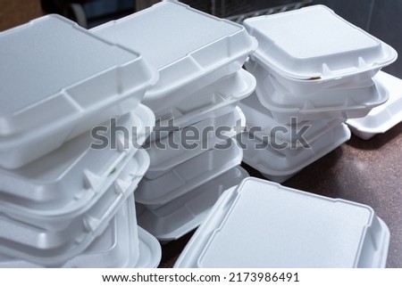 A view of stacks of styrofoam takeout boxes, in a restaurant setting. Royalty-Free Stock Photo #2173986491