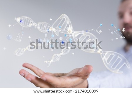 A scientist studying a 3D rendering of DNA strands hologram Royalty-Free Stock Photo #2174010099