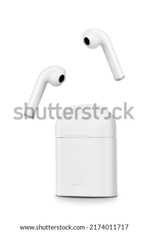 A closeup of white earphones on a white background