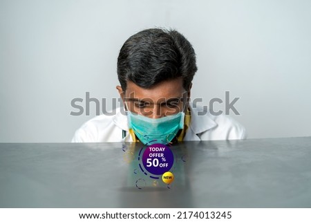 Special offer symbol. young doctor analysing the advertisement 50 percent offer 