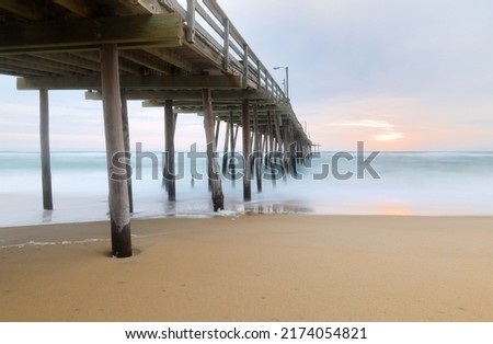 Beautiful sunrise at Nags Head Pier, Outer Banks, North Carolina, USA.  Nags Head is one of the most popular beach of the outer Banks for its  wealth of amenities, sprawling ocean and soundfront view Royalty-Free Stock Photo #2174054821