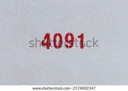 Red Number 4091 on the white wall. Spray paint.
