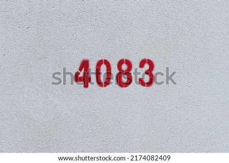 Red Number 4083 on the white wall. Spray paint.

