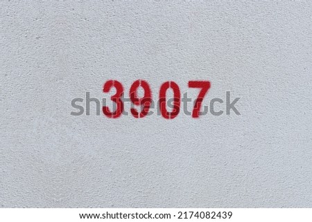 Red Number 3907 on the white wall. Spray paint.
