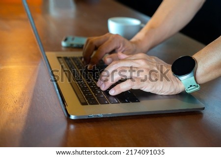 Man using laptop with coffee cup , searching web, browsing information, having workplace at home  soft focus picture  Vintage concept