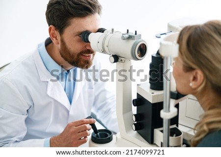 Close-up view of a optometrist checks patient's vision in an optics store or ophthalmology clinic Royalty-Free Stock Photo #2174099721