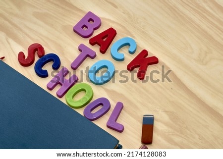 the phrase back to school is laid out in multicolored letters on the table a fountain pen a book a ruler a pencil next to the concept of education school. High quality photo