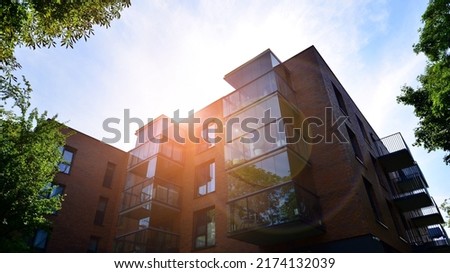 Eco architecture. Green tree and apartment building. The harmony of nature and modernity. Royalty-Free Stock Photo #2174132039