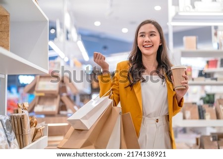 Beautiful asian female woman girl is holding shopping bags and coffee drink, walk and cheerful enjoy smiling while doing shopping in female boutique department store malls happiness window shopping
