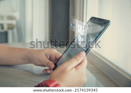 Female using smartphone shopping online with popup notification sale 50% , woman using mobile digital online and social media have a promotion sale on phone screen