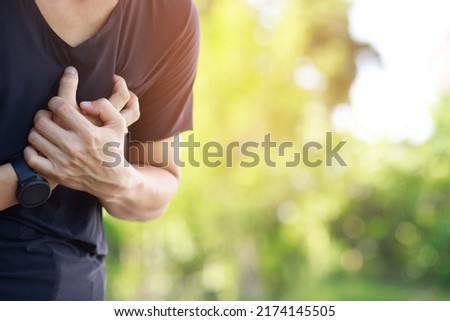 Man having chest pain - heart attack outdoors. or Heavy exercise causes the body to shocks heart disease	