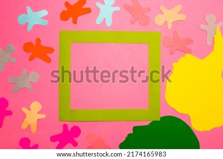 green frame as copy space, around the frame paper people and paper head, colorful minimalism, creative design on the pink background