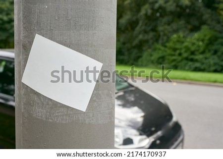   blank white sticker with space for text on roadside pillar                             