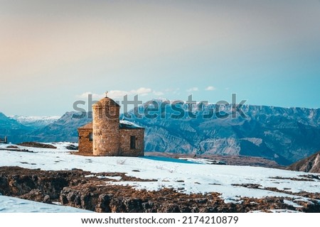 Beautiful scenic view of old monastery at winter Caucasus mountains, covered with snow. Republic of Dagestan, Russia Royalty-Free Stock Photo #2174210879