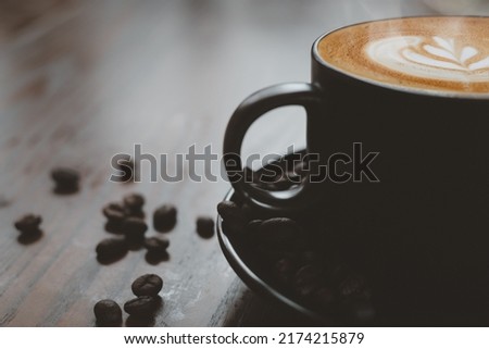 Cup of latte, art coffee on wooden table background, close-up with copy space for text.