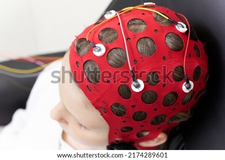 Girl wearing headgear during a session of biofeedback therapy Royalty-Free Stock Photo #2174289601