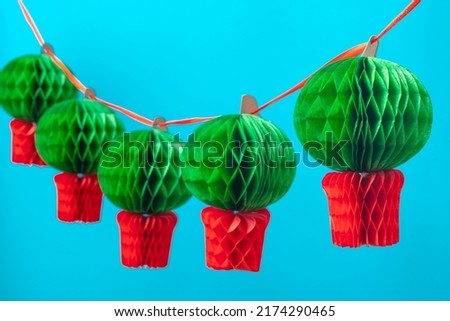 Manjerico paper garland against the blue background. Traditional Summer festival in June San Juan, Portugal Royalty-Free Stock Photo #2174290465