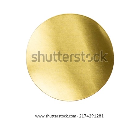 Blank golden round adhesive paper metallic sticker label isolated on white background