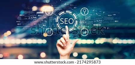 SEO concept with hand pressing a button on a technology screen
