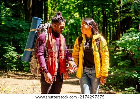 latin american man and hispanic woman in a forest having a rest