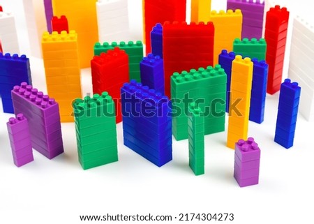 colored blocks of a plastic constructor on a white background in the form of multi-storey buildings. concept of modern buildings and houses