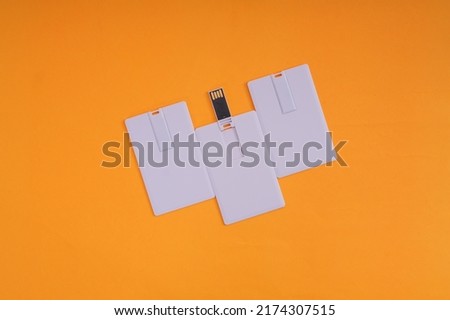 White USB flash disk card on orange background