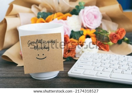 Good morning Monday greeting on a adhesive note with cup of coffee