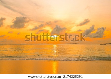 picturesque sunrise in the Maldives island, the sun rising from the Indian ocean and reflected in the water, travel concept
