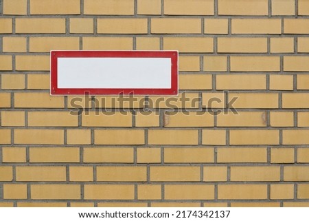 blank white sign with text free space on brick wall
