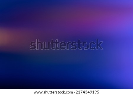 Blur glow overlay. Neon light flare. Futuristic glare. Defocused fluorescent navy blue pink orange color gradient reflection on dark abstract copy space background.