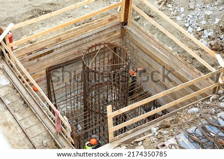 Construction site. Workers making a formwork for a concrete column