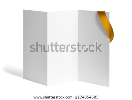 close up of a note card or leaflet brochure with ribbon bow on white background