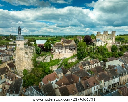 Aerial view of Bourbon-L'Archambault castle of the royal family ruined during the revolution, with three circular towers , Gothic arches surviving on a hilltop over the sleepy small French town 